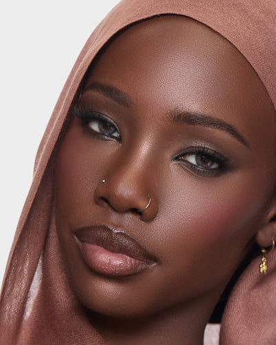 Woman wearing a brown hijab wearing Dimple Color's Saba Grey color contact lenses